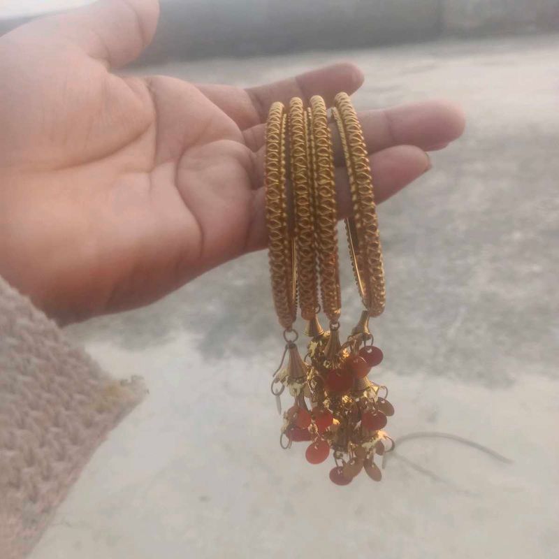 Golden Bangles with Red Bead Charms