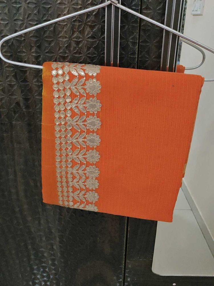 Orange saree with silver embroidery