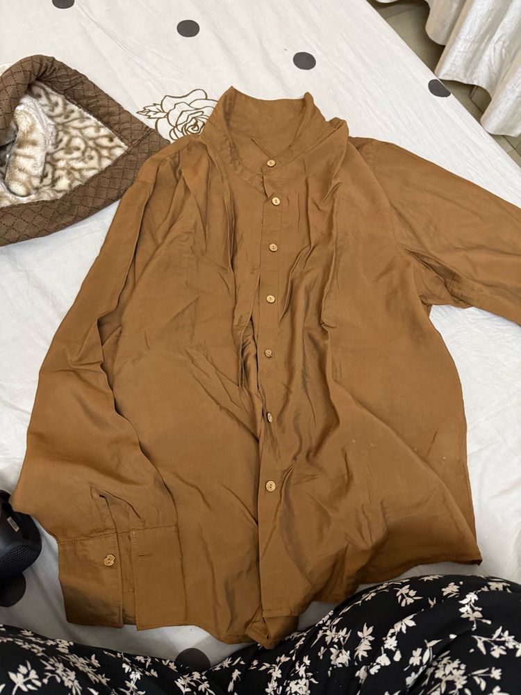 brown fitted shirt with a belt like strand behind