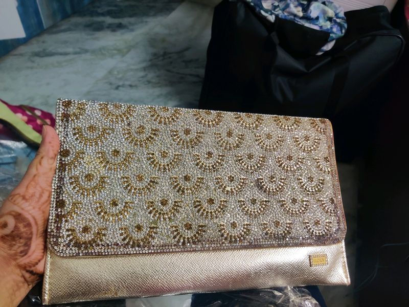golden clutch bag with sling string
