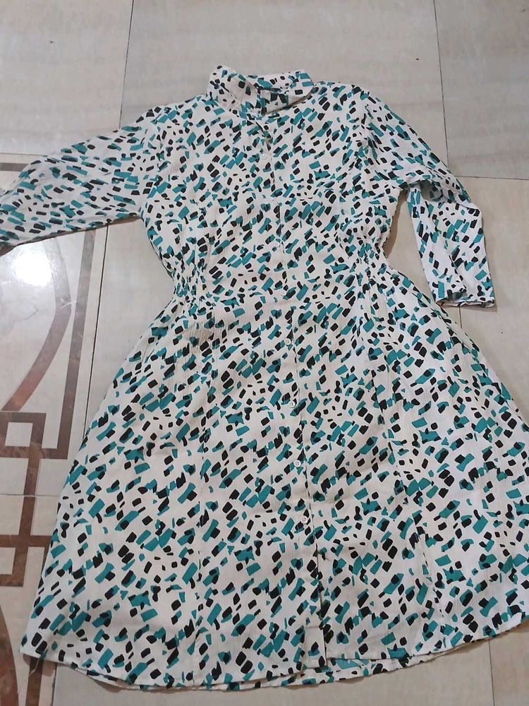 a middi of white colour having green nd black dots