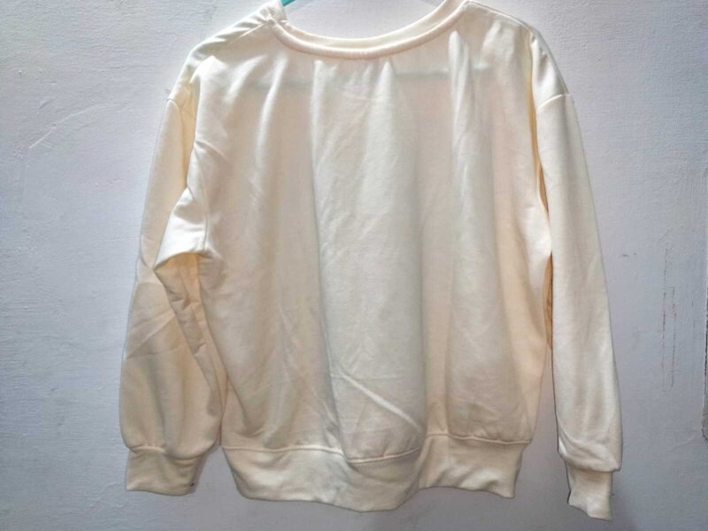 Cream colored crewneck sweater