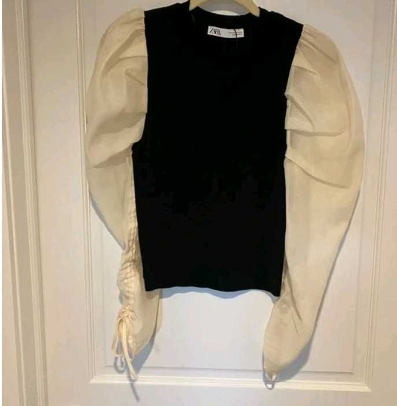 Zara size small black top with cream puffy sleeves