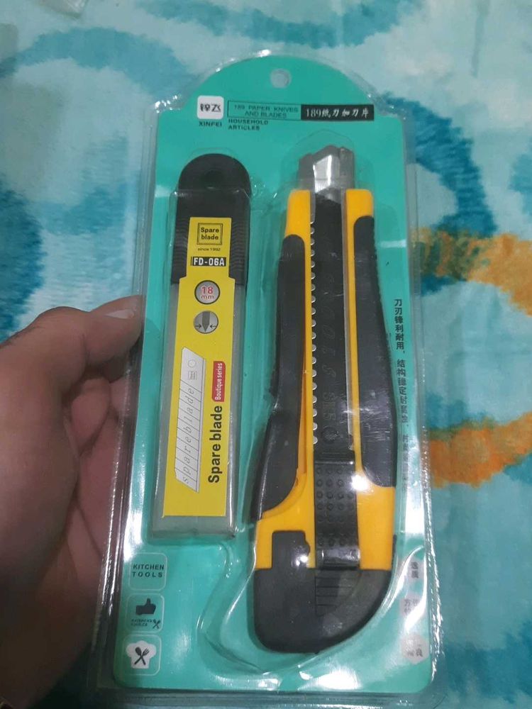 utility knife and a pack of spare blades