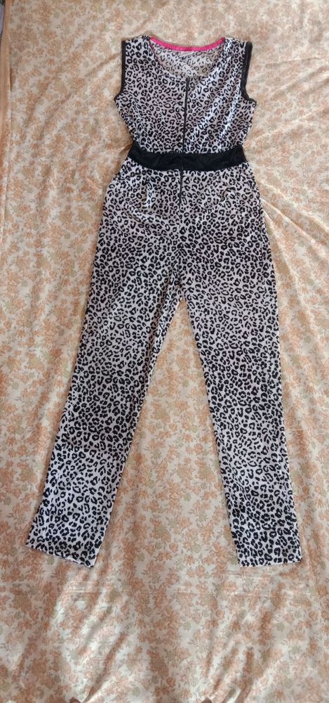 Leather print jumpsuit with a  zipper on top.