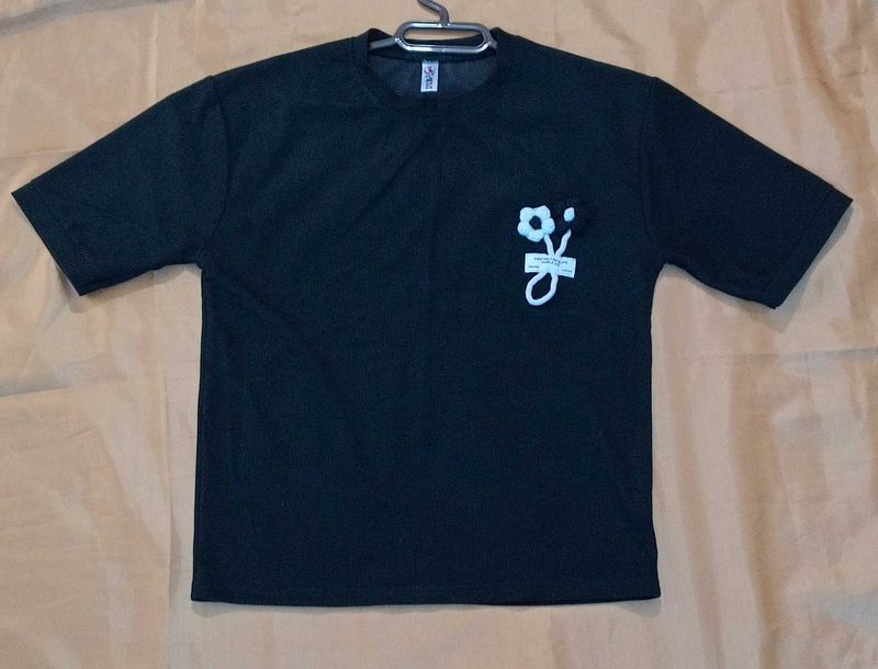 Black top with a knitted flower for women