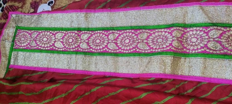Bright red Gujarati leheriyu saree with pink and green border lace with blouse