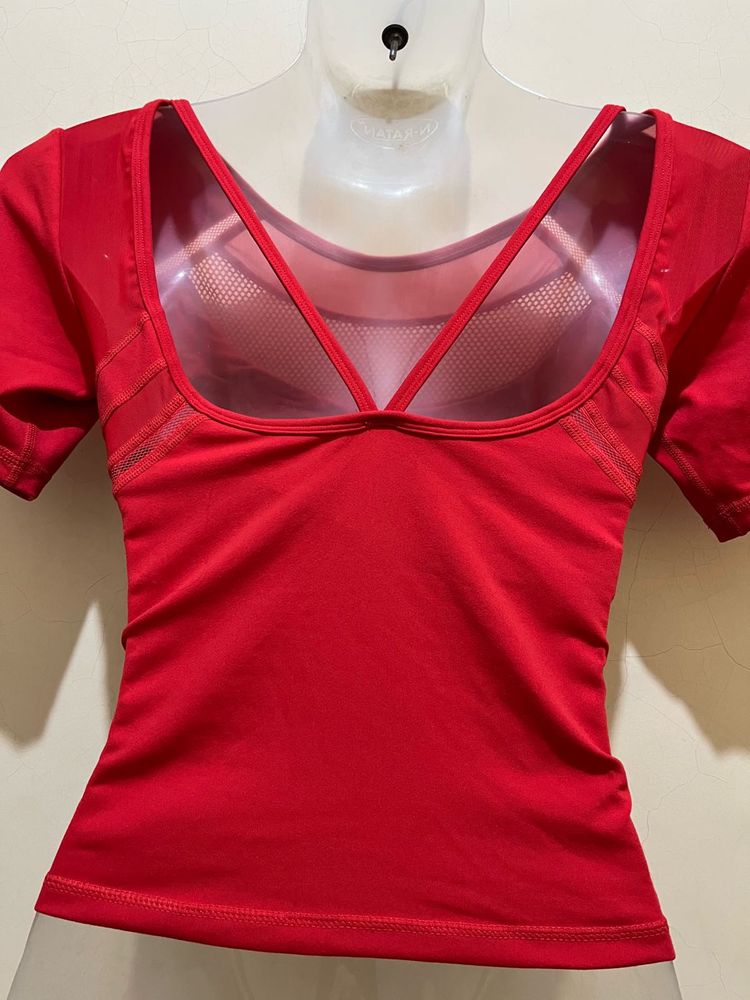 top features a V-shaped strap design at the back