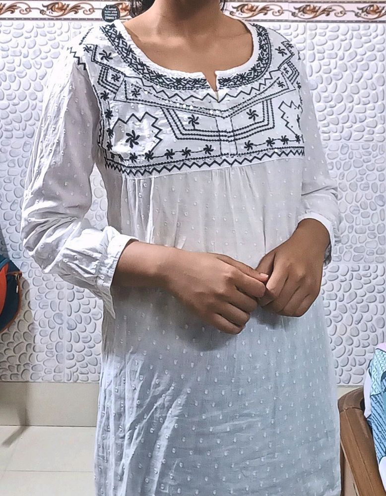 Pure Cotton, White Kurti From The Brand DJ&amp; C.It Has Black Thread Work With Silver Sequins Work.