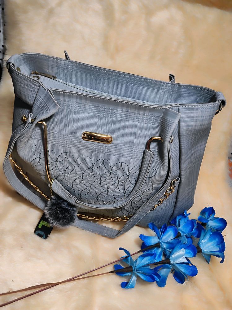 A Sophisticated Grey Handbag With Two Handles