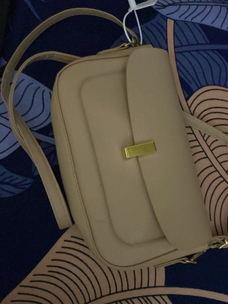 classy beige slingbad/handbag with two belts
