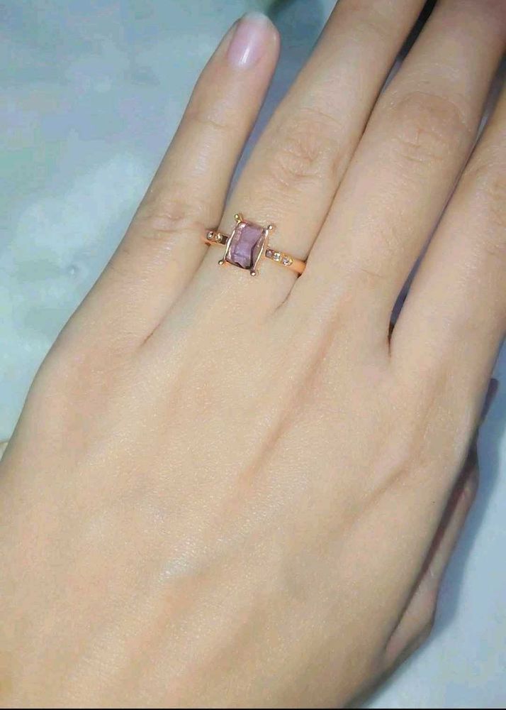 Elegant rose gold ring with a lavender stone.