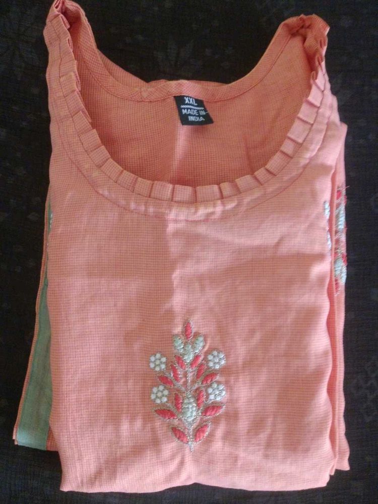 Its a orange Colour Kurta With Hand Work Design