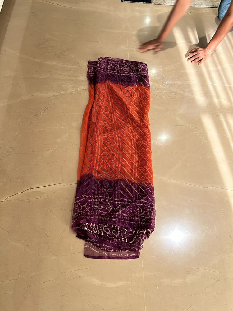 Lovely orange and purple bandhej Saree