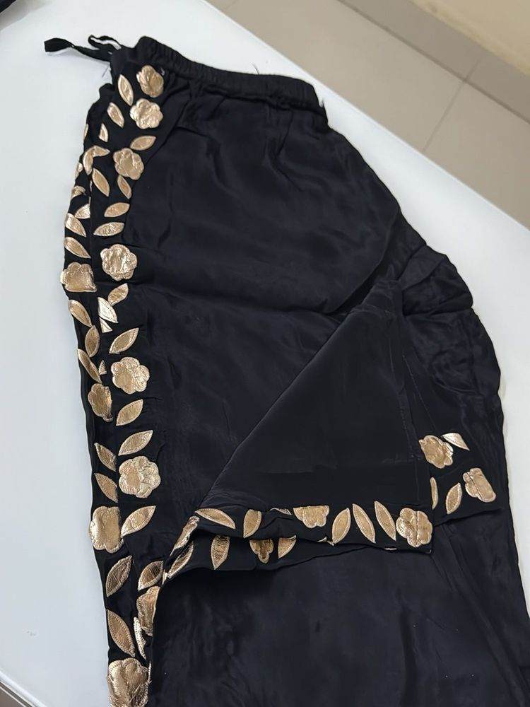 cord set with gold work. black in colour