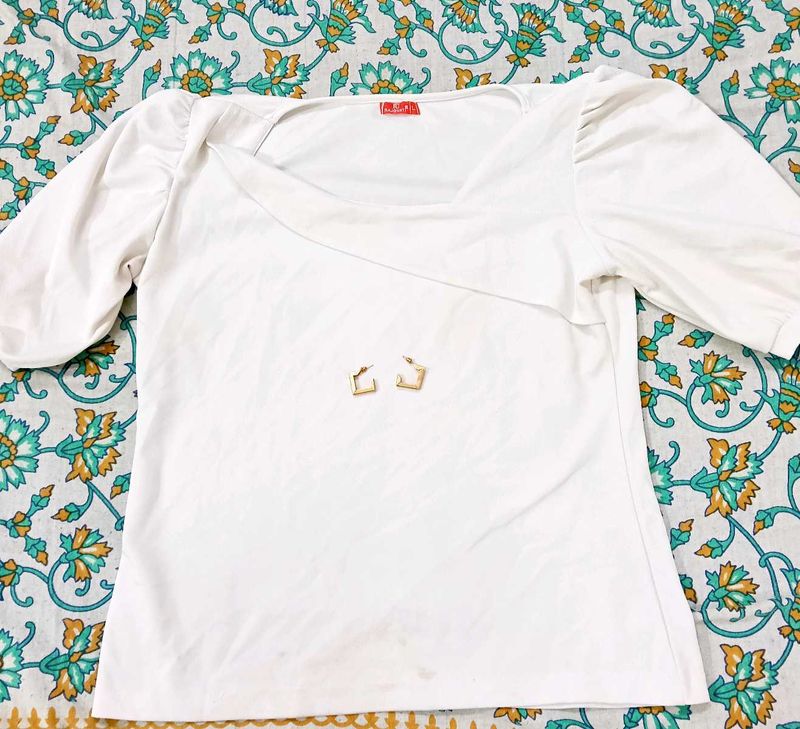White Puff Sleeve Top With Golden Earrings.