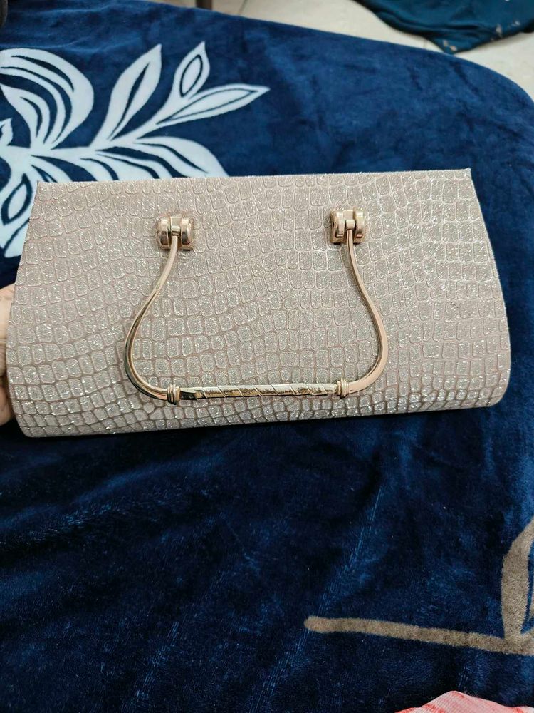 A brand new sparkly gold clutch