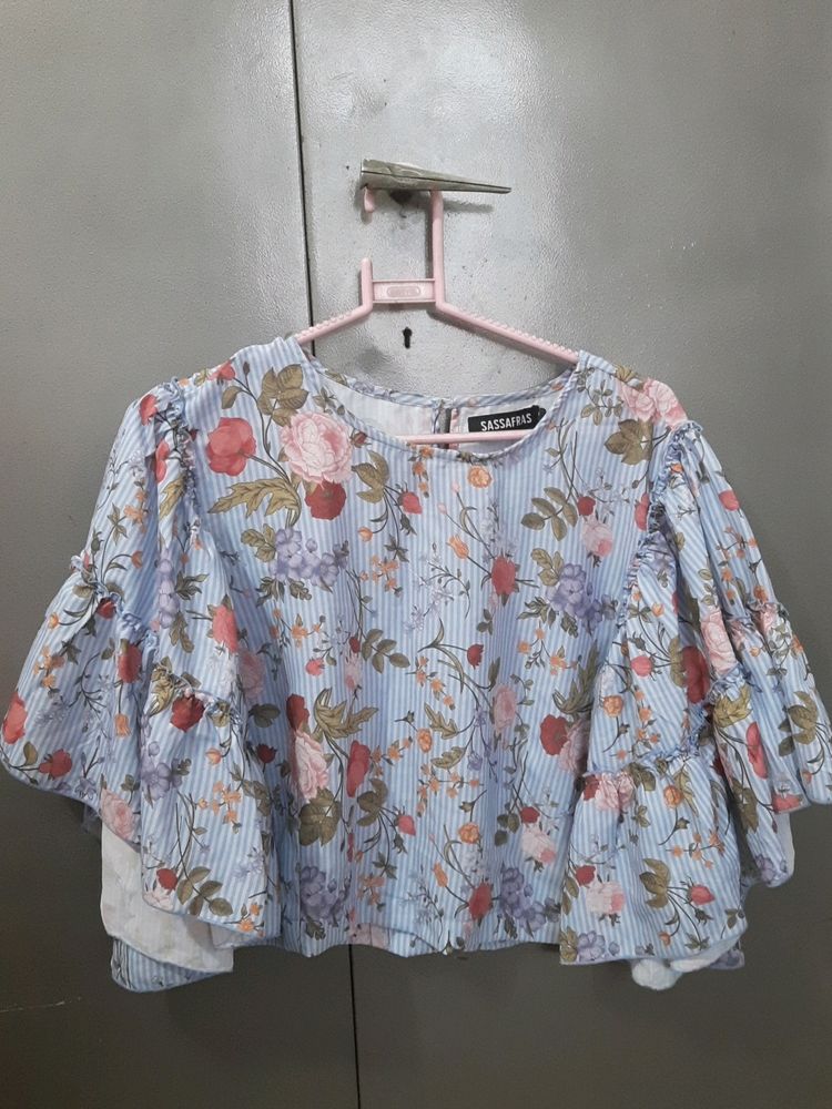 This is a Top From Sassafras . It Is Blue In Colour With Floral Print On It . Sixe Is XL
