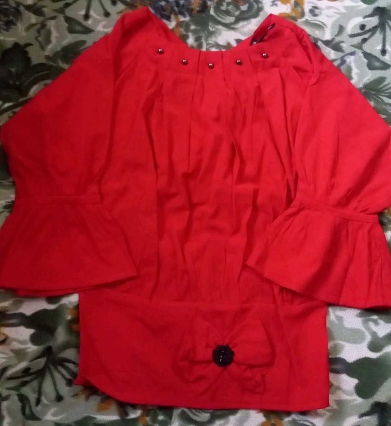A Red Top With Some Black Details
