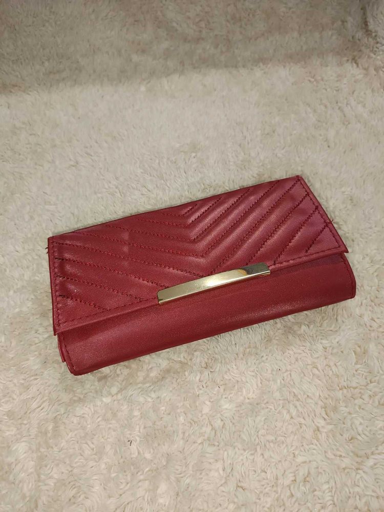 it's new Burgundy Clutch with Gold Detail