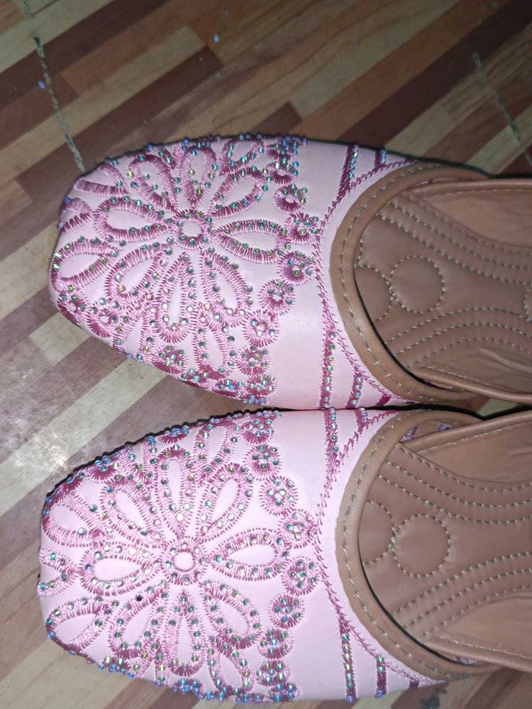 pair of traditional pink embroidered juttis