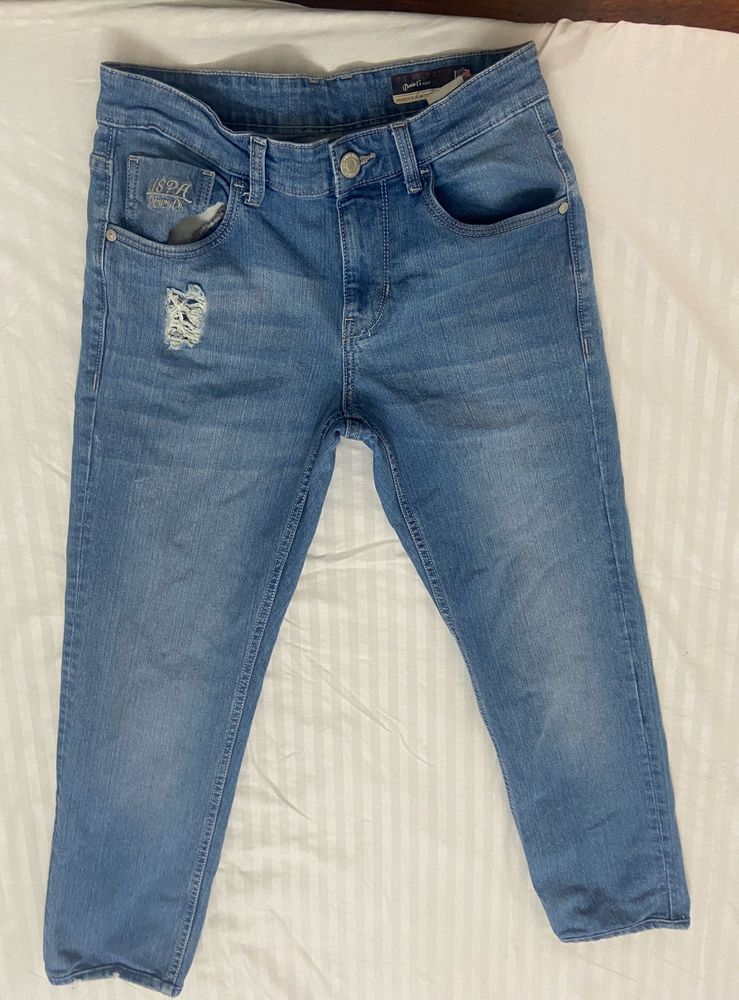 Light blue denim jeans with a cool distressed look
