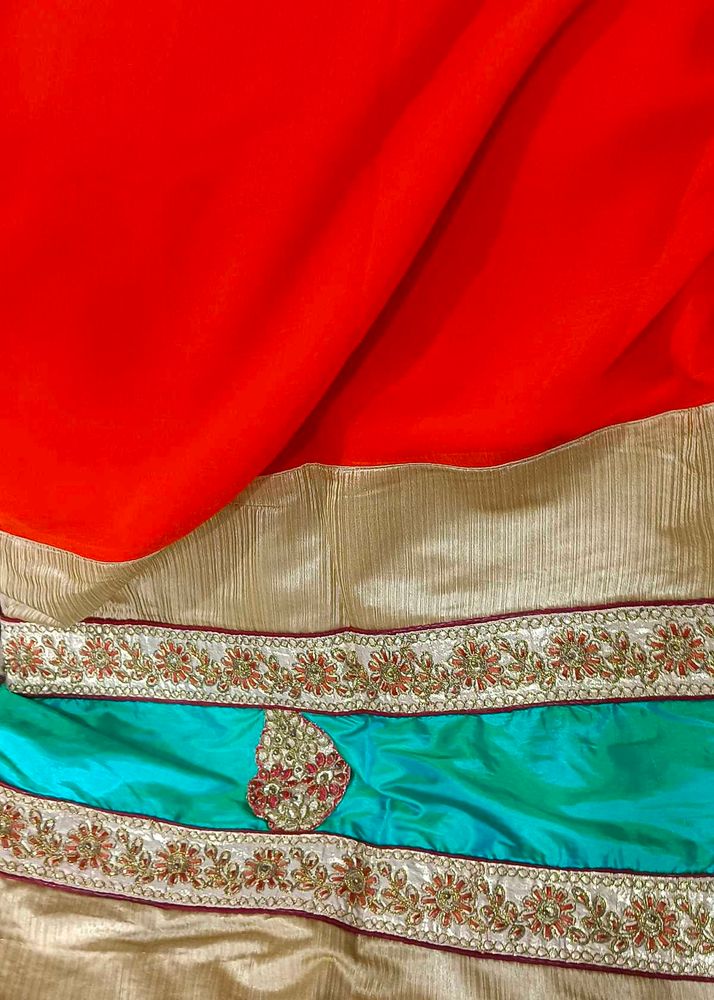 Orange Saree With Turquoise And GoldenBorder