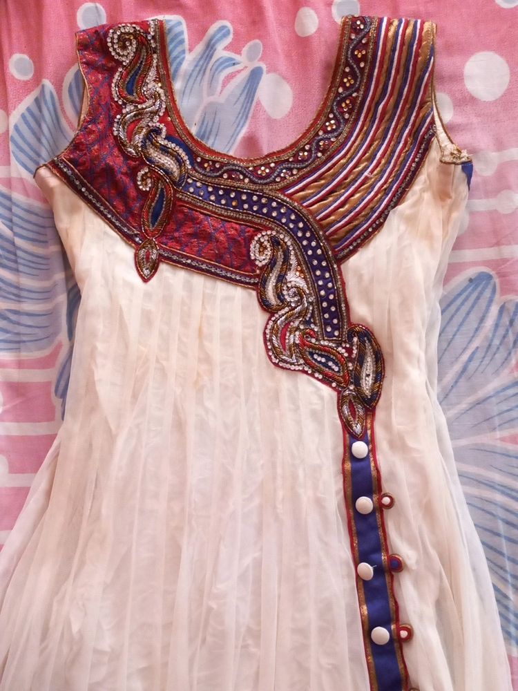 Off white net anarkali with beautiful neckline and beads embroidery. Full length anarkali