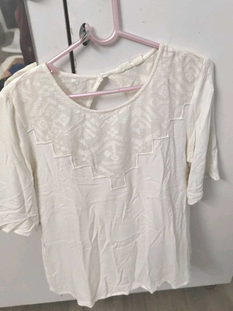 Elegant White Top With Geometric Detailing