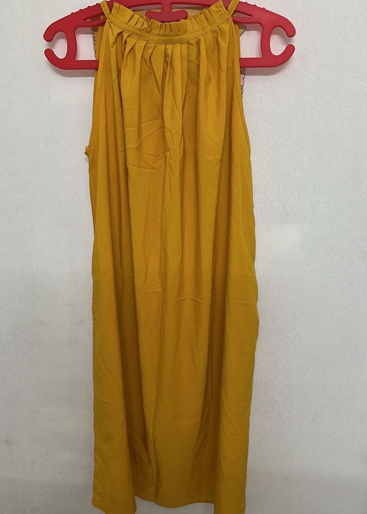 sleeveless mustard yellow top with a halter-style