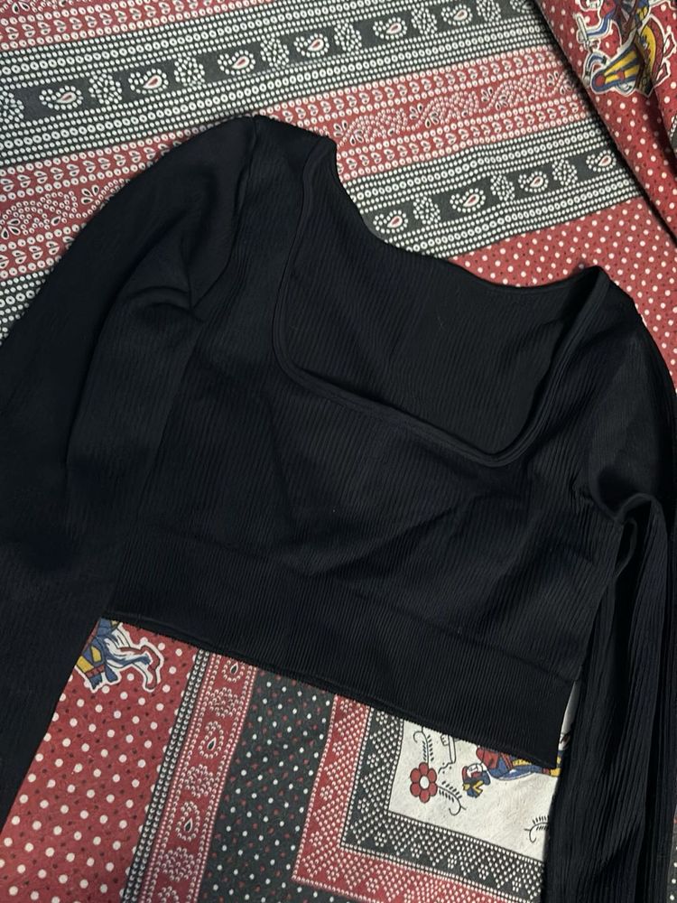 Black fitted long sleeve crop top with a thumbhole
