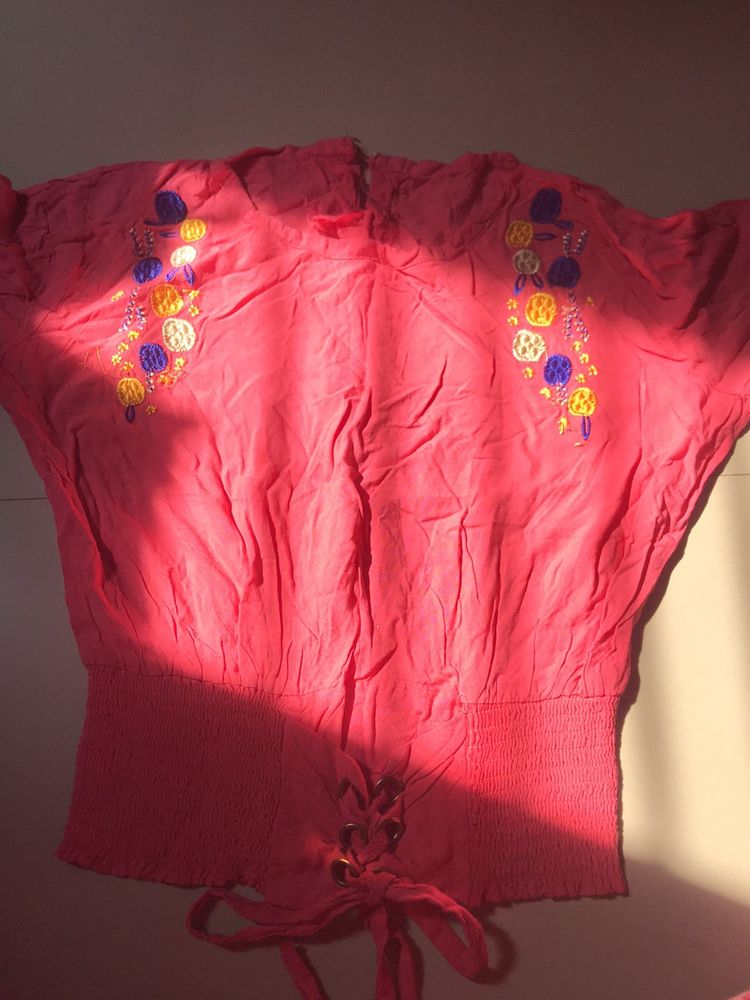 pink stretchy top with flowers embodery