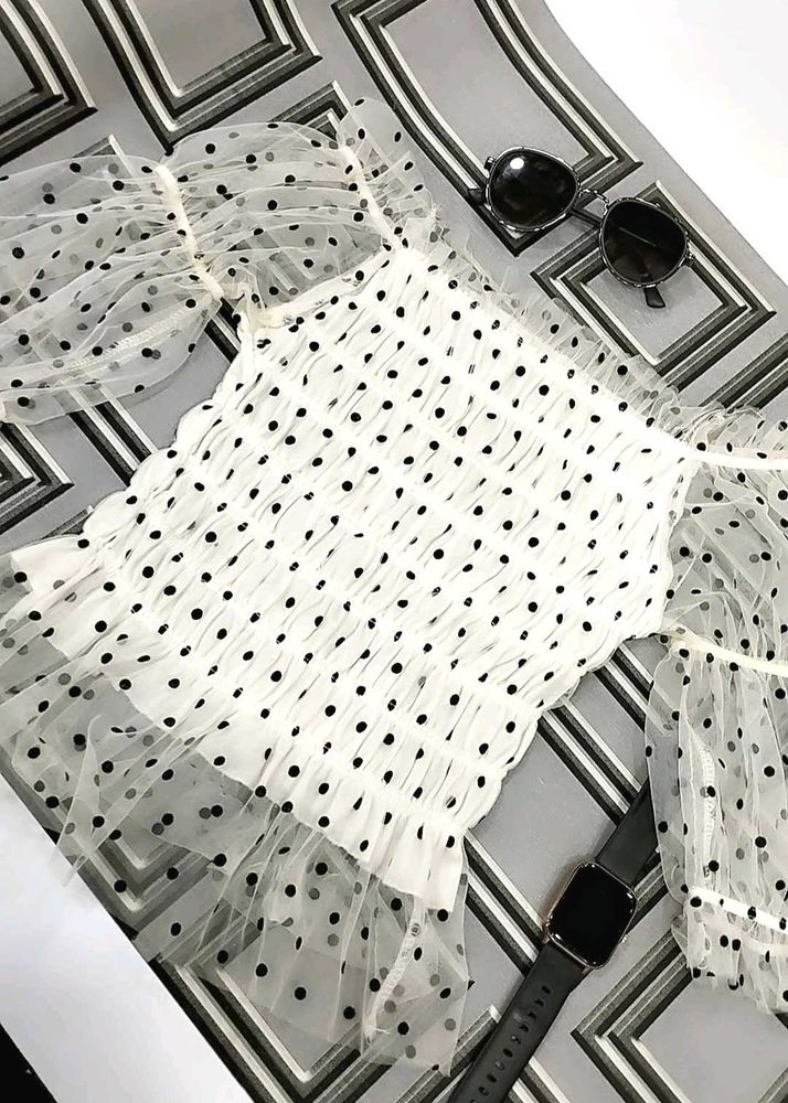 white, sheer top with black polka dots