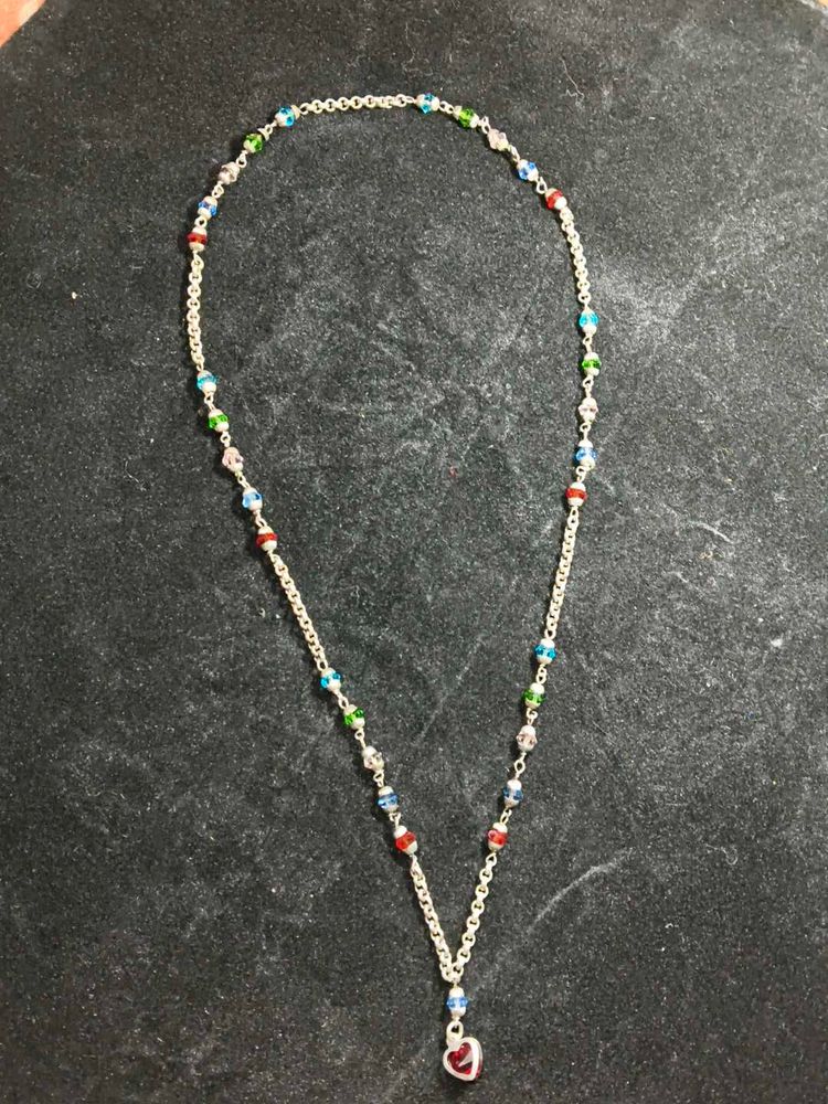 White metal chain with colourful pearls.