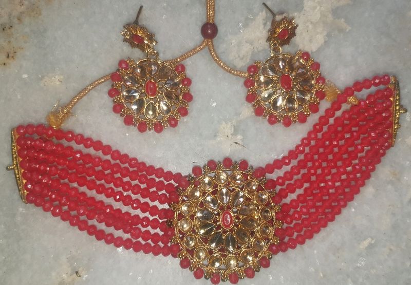 Red  chokar set with earing Base Metal:   Choker and EarringsRed  chokar set with earing  this jwellery set looks beautiful with traditional dress like lehenga saree and suits etc.